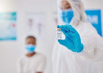 Image showing Covid, corona virus vaccine or vaccination with healthcare worker hands showing liquid glass container or bottle. Medical doctor preparing a coronavirus prevention dosage shot for patient in hospital