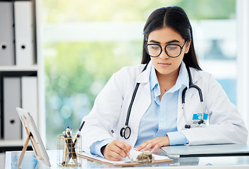 Image showing Doctor, insurance and medical of a woman filling out patient history for diagnosis at the hospital. Healthcare worker or nurse writing on paper with clipboard for health and wellness at the office.