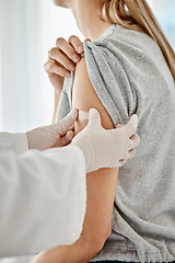 Image showing Covid, vaccine and doctor applying plaster to patient after receiving medical treatment during pandemic. Close up of healthcare worker putting on medic patch after consulting a woman at hospital.