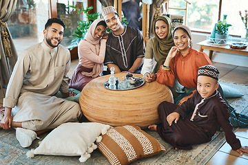Image showing Happy muslim family celebrating ramadan together, smiling and bonding in living room. Relaxed relatives spending the day embracing religious holiday. Islamic siblings gathering in their family house