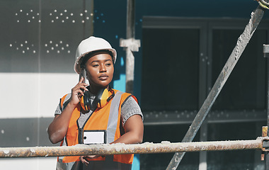 Image showing Construction worker talking on a phone call while standing in a building site. Professional builder discussing plans and strategy, checking the inside structure. Civil engineer doing a safety check