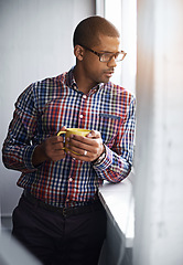Image showing Business man taking a break while looking out of the window. African American male relaxing indoors by viewing outside urban activity. Office worker watching city life below the building.