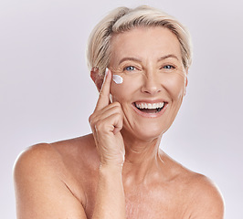 Image showing Skincare, beauty and wellness cream of happy senior woman with smile for skin care on her face in a studio background. Portrait of a mature model lady in beauty, wellness and health and cosmetics.