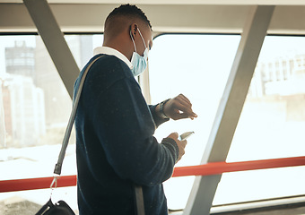 Image showing Travel businessman with covid face mask on his way to corporate or business opportunity in the city. Young black business man checking time, running late due to covid 19 airport delay and compliance