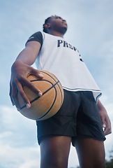 Image showing Basketball athlete ready for training, game and competition on sports court from below outdoor. Thinking, focus and fitness young black man with motivation, mindset and goal to play, win and have fun