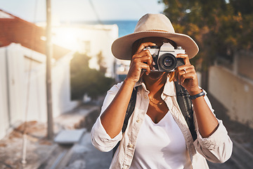 Image showing Photographer, travel or tourist taking pictures or photos outdoors in a new town. Traveler using a camera while on a trip at a vacation or holiday location on a sunny day doing a photoshoot