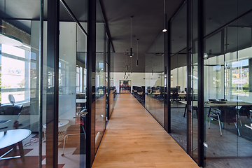 Image showing In a setting of modern, glass-walled business startup offices, the open, airy workspace reflects a contemporary and innovative ambiance, promising a dynamic environment for entrepreneurial growth