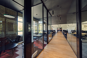 Image showing In a setting of modern, glass-walled business startup offices, the open, airy workspace reflects a contemporary and innovative ambiance, promising a dynamic environment for entrepreneurial growth