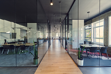 Image showing In a setting of modern, glass-walled business startup offices, the open, airy workspace reflects a contemporary and innovative ambiance, promising a dynamic environment for entrepreneurial growth