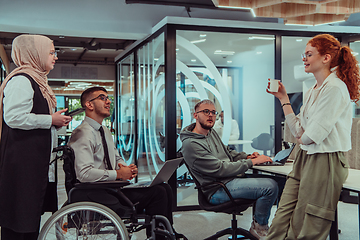 Image showing Young group of business people brainstorming together in a startup space, discussing business projects, investments, and solving challenges.