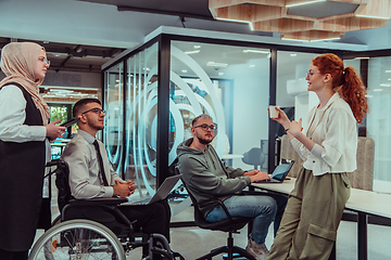 Image showing Young group of business people brainstorming together in a startup space, discussing business projects, investments, and solving challenges.