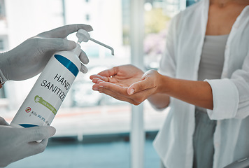 Image showing Sanitizer or sanitizing woman cleaning her hands to prevent the spread of covid at the airport. Closeup of a female using antibacterial disinfectant for coronavirus protection in a modern building