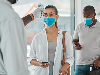 Image showing Compliance, travel and covid restrictions by security scanning tourist temperature with a infrared thermometer at airport. Worker checking or fever for other corona related symptoms at work