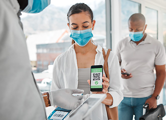 Image showing Covid passport, QR code or travel with security scanning a woman in airport arrival or departure lounge. Safety, immigration and refugee status with control of people during the corona virus pandemic