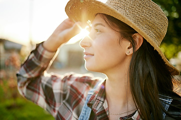 Image showing Farm, agriculture and woman farmer working in the field during spring at sunset to monitor growth. Wellness, sustainability and eco friendly female standing in a green, agro and sustainable garden.