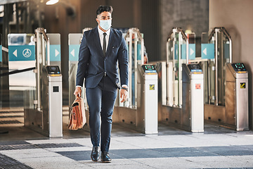 Image showing Covid, health and safety on public transport, a businessman walking in a bus or train station in a business suit and face mask. Career, travel and an office worker on his morning journey in the city.