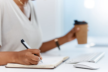 Image showing A business woman writing notes in a notebook or managing her schedule in a diary or completing a journal in an office. Closeup of an assistant working on a notepad learning from the internet