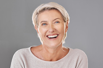 Image showing Grooming, skincare and face of happy mature woman laughing against a studio grey background. Senior female feeling fresh, enjoying free time with self care hygiene treatment. Joy after routine pamper