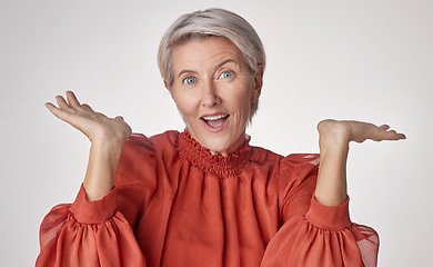 Image showing Wow and surprise senior woman with emoji hand gesture or expression on studio grey background. Senior fashion business lady with hands for shocking unbelievable pension deal, discount or sale