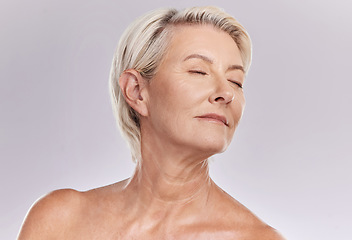 Image showing Beauty, skincare and face of a senior woman posing with closed eyes and topless against grey studio background. Happy old, elderly or mature female with glowing skin due to cosmetic self care