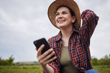 Image showing Agriculture, nature and 5g connection by farmer texting on a phone, reading social media while relaxing outdoors. Happy worker browsing the internet for natural sustainability tips, products online