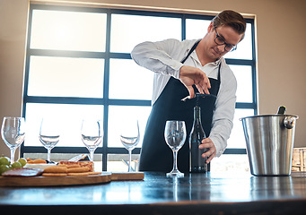 Image showing Bartender with red wine tasting at luxury restaurant or vineyard and vintage alcohol bottle and glasses for fine dining, culinary or hospitality industry. Sommelier service with quality alcohol drink