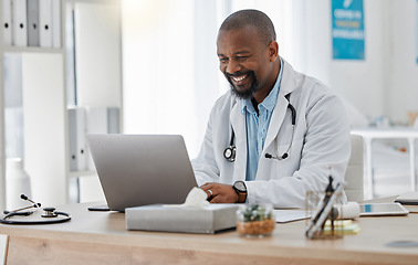 Image showing Doctor, medical and healthcare worker on laptop checking history or medical data at hospital or clinic working with tech. GP man on computer reading emails, patient records and documents