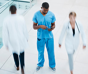 Image showing Healthcare, doctors and a nurse on a tablet, in a hospital or clinic corridor. Medical worker consulting patients chart online before surgery. Management, teamwork and innovation to help health care.