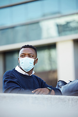 Image showing Covid, travel restrictions and immigration with a man in a mask waiting outside of the airport in the day. Flight delay and ban due to safety, control and regulations in the corona virus pandemic