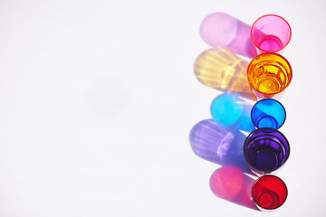 Image showing Party color empty water glasses on table for birthday celebration at pub or whisky cocktail event mock up. Whiskey, vodka or tequila shots alcohol beverage in glass together and ready from bartender