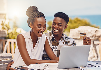 Image showing Happy couple online shopping with laptop and credit card payment on ecommerce website with a smile during vacation. Man and woman buy on the internet or pay bills, tax and finance while in summer
