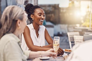 Image showing Champagne, celebration and happy women at a restaurant or social event eating at a table with lens flare and fine dining background. Black woman with a smile having food and conversation with friends