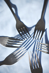 Image showing Restaurant service and silver group of fork display on a table for catering service or food industry. Top zoom view of clean, metal or steel cutlery, kitchenware and kitchen tableware equipment