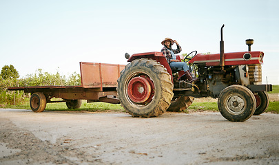 Image showing Farm, tractor and agriculture with happy woman farmer driving a vehicle on farm for sustainability, growth and development in a sustainable and green environment. Farming crops in the harvest season