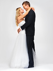 Image showing Couple and wedding with a happy bride and groom in studio against a white background. Dress, suit and marriage with a man and woman getting married at a celebration event or ceremony