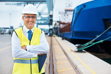 Image showing Industrial worker working on a shipping port to export stock, containers and packages. Portrait of logistics, business and industry employee with a crane at a cargo freight warehouse dock.