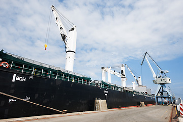 Image showing Shipping, logistics and supply chain with a ship in a harbor for freight and cargo delivery. Shipment, courier and service with a commercial and industrial vessel in the export and transport industry