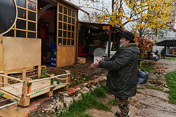 Image showing In the historic city of Riga, a bearded elderly man passionately explains the traditional symbolism of Halloween, connecting generations through cultural heritage and folklore.