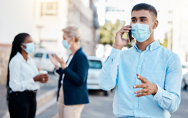 Image showing Covid, medical mask and phone call businessman talking on 5g network, mobile or smartphone outside with team in background. Communication, teamwork and collaboration with worker on cellphone.