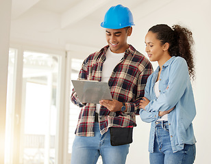 Image showing Couple planning home renovation job together, construction worker working with woman on maintenance and remodeling of apartment. Contractor and builder helping with interior design of family home