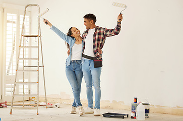 Image showing Couple painting room for interior house renovation and home or property design project with smile, white wall background mockup. New home or apartment and happy painter people with DIY hardware