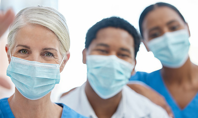 Image showing Team selfie of doctors with mask for safety against covid, corona pandemic, or virus in a hospital. Portrait of healthcare employee or medical workers together for support, teamwork and collaboration
