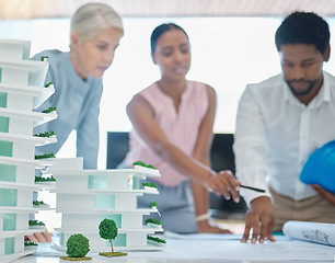 Image showing Architect or engineer team planning and designing a building in a meeting in the office or boardroom. City development planner or architecture group with a 3d model and working on a strategy