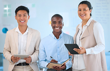 Image showing Teamwork, collaboration and meeting with a team using a notebook and tablet technology. Portrait of a diverse group of business people working in an office with a vision and mission of growth