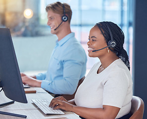 Image showing Call center, office and contact us of a woman agent in customer support with happy smile in the workplace. Telemarketing employee working on a computer in the communication business at work.