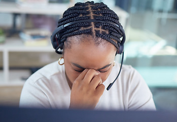 Image showing Stress, burnout and sad call center agent with a headache and office overworked sitting in an office. Frustrated, sick or ill young black woman customer service employee with pain or migraine