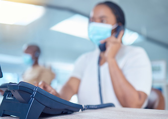 Image showing Business woman or receptionist on phone call with a mask for covid, corona or virus safety. Company office worker in startup workplace consulting or communication with client about telemarketing sale