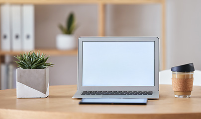 Image showing Mockup laptop, coffee and tablet on desk at home office of freelance SEO, UX or digital social media marketing and advertising freelancer. Internet or online work from home remote workspace