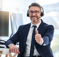 Image showing Thumbs up, yes and success deal for a call center agent with contact us and happy about telemarketing. Portrait of a CRM manager or customer service employee smiling due to good business