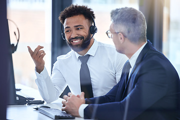 Image showing Call center agent or telemarketing employee consulting a business man and talking about company growth. Happy male customer service employee in training with an HR manager at the office